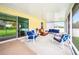 View of the screened porch with comfortable outdoor seating and sliding glass doors at 1888 Creeks Vista Blvd, Lakeland, FL 33810