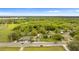 Aerial view of property in a green, wooded area near a main road with other houses at 1925 N Combee Rd, Lakeland, FL 33801