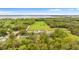 Aerial shot of the property location in a serene, tree-filled area close to the water at 1925 N Combee Rd, Lakeland, FL 33801