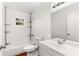 Bright bathroom with white tile and white fixtures featuring a shower-tub combo at 1925 N Combee Rd, Lakeland, FL 33801