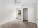 Bright bedroom with plush carpet, neutral paint, a ceiling fan, and a closet with sliding doors at 1925 N Combee Rd, Lakeland, FL 33801