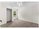 Bright bedroom with plush carpet, neutral paint, a ceiling fan, and a closet with sliding doors at 1925 N Combee Rd, Lakeland, FL 33801