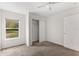 Bright bedroom with plush carpet, neutral paint, and a closet with sliding doors at 1925 N Combee Rd, Lakeland, FL 33801