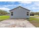 Rear exterior showing the freshly painted home and parking pad at 1925 N Combee Rd, Lakeland, FL 33801