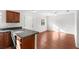 An open kitchen flows into a dining area that features wood floors and plenty of natural light at 1925 N Combee Rd, Lakeland, FL 33801