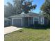 Charming single-story home features a well-maintained lawn and attached garage with a driveway at 2014 S Lake Cannon Nw Dr, Winter Haven, FL 33881