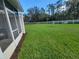 Spacious backyard with well-maintained lawn, lined with mulch, and a white fence at 2051 Winterset Dr, Lakeland, FL 33813