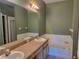 Bathroom featuring soaking tub and separate glass enclosed shower at 2051 Winterset Dr, Lakeland, FL 33813