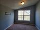 Cozy bedroom featuring carpet flooring, natural light from a window, and neutral paint at 2051 Winterset Dr, Lakeland, FL 33813