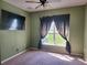 Bedroom features a ceiling fan, plush carpeting, and a large window with a view at 2051 Winterset Dr, Lakeland, FL 33813