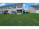 Townhouse exterior featuring a well-maintained lawn and view of the back of the building at 2051 Winterset Dr, Lakeland, FL 33813