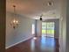 Bright living room featuring hardwood floors, a ceiling fan, and sliding door access to the screened lanai at 2051 Winterset Dr, Lakeland, FL 33813