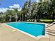 Sparkling community pool with lounge chairs and clear blue water at 2051 Winterset Dr, Lakeland, FL 33813