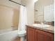 Bathroom featuring a shower-tub combo and a single sink vanity with a wood cabinet at 2170 Country Manor St, Bartow, FL 33830