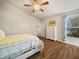 Cozy bedroom with wood-look floors, a window with blinds, and a neutral color scheme at 2170 Country Manor St, Bartow, FL 33830