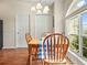 Dining area with a wood table, chairs and a sun-filled window with views of the outdoors at 2170 Country Manor St, Bartow, FL 33830