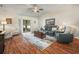 Cozy living room featuring sliding glass doors, wood-look flooring, and comfortable furniture at 2170 Country Manor St, Bartow, FL 33830