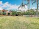 Exterior view of the clubhouse with a manicured lawn and mature landscaping near the pool at 2206 Silver Lakes N Dr, Lakeland, FL 33810