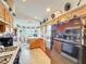 Functional kitchen with wooden cabinets, a black refrigerator, and an open eating area at 2206 Silver Lakes N Dr, Lakeland, FL 33810