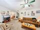 Cozy living room featuring carpet flooring, a ceiling fan, and neutral-colored furniture at 2206 Silver Lakes N Dr, Lakeland, FL 33810