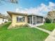 The rear exterior features a screened-in lanai with a paver walkway and manicured landscaping at 2206 Silver Lakes N Dr, Lakeland, FL 33810