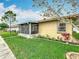 The rear exterior features a screened-in lanai, and well-manicured flowerbeds at 2206 Silver Lakes N Dr, Lakeland, FL 33810