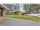 View of a flat backyard featuring mature trees, a small storage shed, and wood fencing at 2330 Peterson Rd, Lakeland, FL 33812