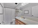 Well-lit bathroom featuring a shower-tub, and updated fixtures at 2330 Peterson Rd, Lakeland, FL 33812