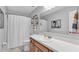 This tidy bathroom features an elegant white countertop and a framed mirror at 2330 Peterson Rd, Lakeland, FL 33812