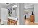 Bright bathroom with a wood vanity, shower and decorative shelving at 2330 Peterson Rd, Lakeland, FL 33812