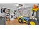 This fun room has a ceiling fan, closet and a race car bed with colorful decor at 2330 Peterson Rd, Lakeland, FL 33812