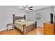 Cozy bedroom with wooden furniture, ceiling fan, and a window providing natural light at 2330 Peterson Rd, Lakeland, FL 33812