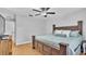 This bedroom is bright and features a ceiling fan and wood-look floors at 2330 Peterson Rd, Lakeland, FL 33812