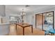 Bright dining room with hardwood flooring, view of the patio, and modern light fixture at 2330 Peterson Rd, Lakeland, FL 33812