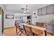 Inviting dining area with wood table, view to living room with stone fireplace and neutral color palette at 2330 Peterson Rd, Lakeland, FL 33812