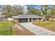 A well-maintained single-story home with an attached garage, a curved walkway, and a green lawn at 2330 Peterson Rd, Lakeland, FL 33812