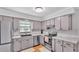 Bright kitchen featuring gray cabinetry, stainless steel appliances, and stylish countertops at 2330 Peterson Rd, Lakeland, FL 33812