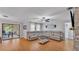 Bright living room featuring a spacious sectional, wood floors, and access to outdoor space at 2330 Peterson Rd, Lakeland, FL 33812