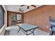 This bright sunroom features a grill, ceiling fans, concrete flooring, and a large table at 2330 Peterson Rd, Lakeland, FL 33812