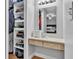 Open walk-in closet is a dressing room with a vanity and bright overhead lighting at 2330 Peterson Rd, Lakeland, FL 33812