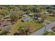 Expansive aerial view of a well-maintained home with lush landscaping and detached garage at 2465 Thornhill Rd, Auburndale, FL 33823