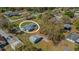 An aerial shot showcasing a cozy home with a detached garage, nestled in a serene neighborhood at 2465 Thornhill Rd, Auburndale, FL 33823