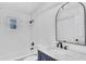 Bathroom featuring white subway tile in shower, with white vanity and marble top at 2465 Thornhill Rd, Auburndale, FL 33823