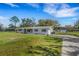 Lovely home exterior featuring a well-kept lawn, classic brick facade, and attached garage at 2465 Thornhill Rd, Auburndale, FL 33823