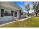 Inviting front porch with decorative columns and a charming welcome sign at 2465 Thornhill Rd, Auburndale, FL 33823