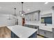 Kitchen featuring a large island, gray cabinetry, and a view into the adjacent living space at 2465 Thornhill Rd, Auburndale, FL 33823