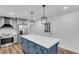 Modern kitchen island features a white countertop, blue cabinets, and pendant lighting at 2465 Thornhill Rd, Auburndale, FL 33823