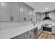 Well-appointed kitchen with gray cabinetry, stainless steel appliances, and a white countertop at 2465 Thornhill Rd, Auburndale, FL 33823