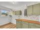 Well-lit laundry room with a butcher block countertop and floral wallpaper at 2465 Thornhill Rd, Auburndale, FL 33823