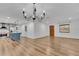 Bright living room featuring wood floors and an open layout connected to the modern kitchen at 2465 Thornhill Rd, Auburndale, FL 33823